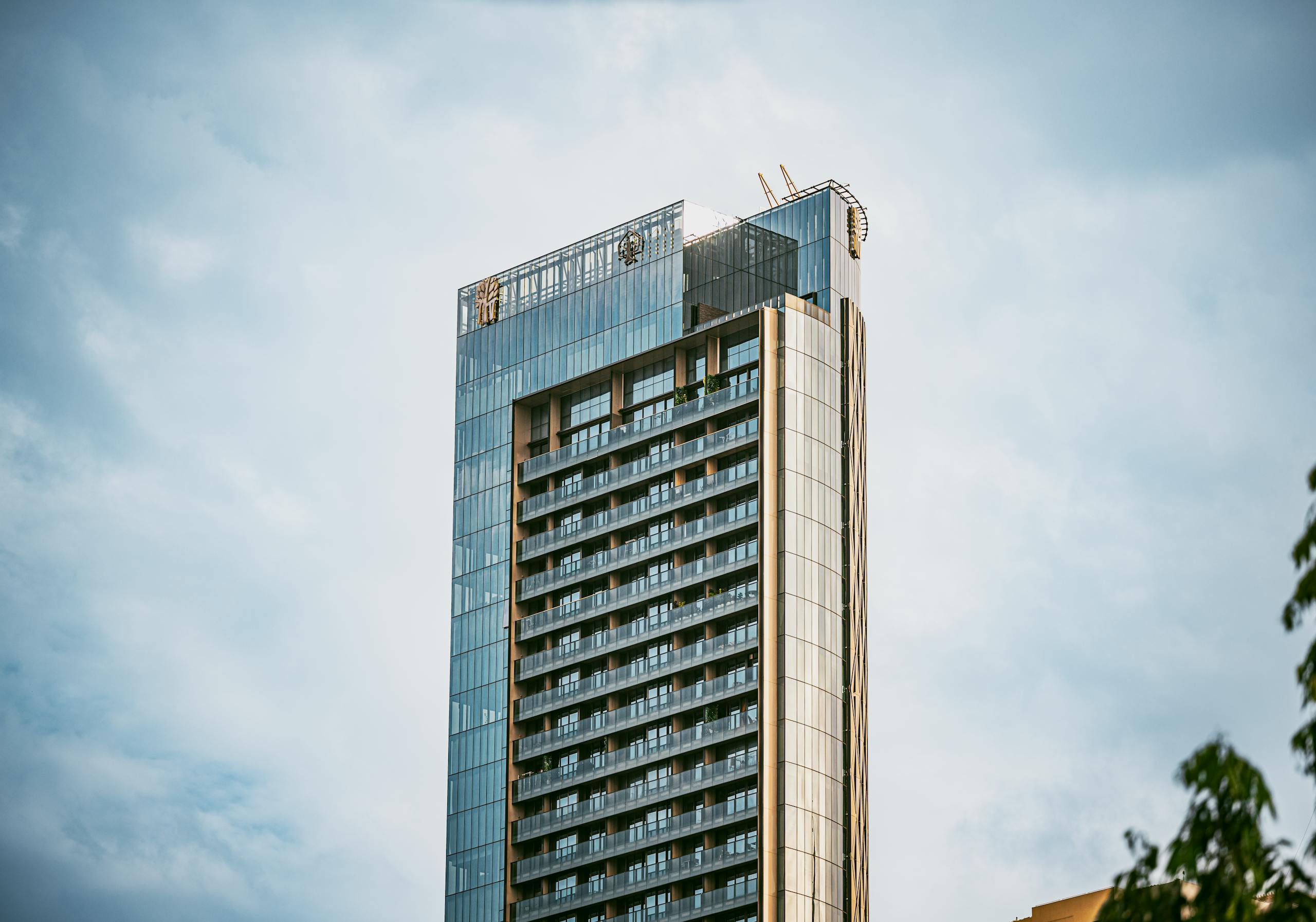 A modern skyscraper with glass facade in central Bangkok, capturing urban architecture.